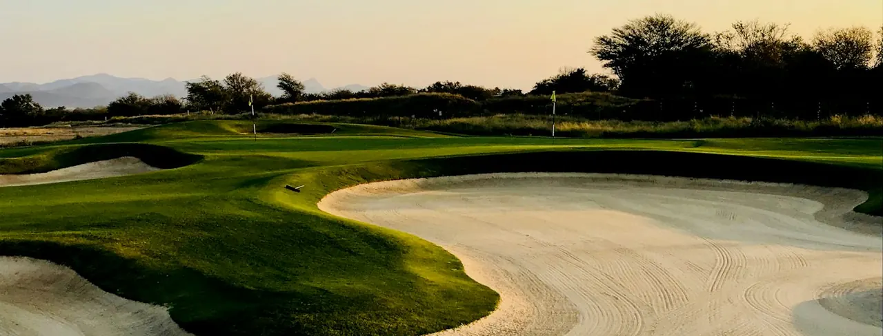 Evening light over a bunker and green